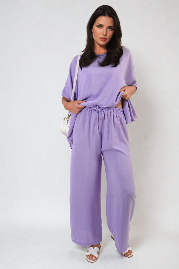 Woman wearing Drawstring Waist Wide Leg Trousers, showcasing their relaxed fit and adjustable drawstring waist, ideal for versatile everyday style.