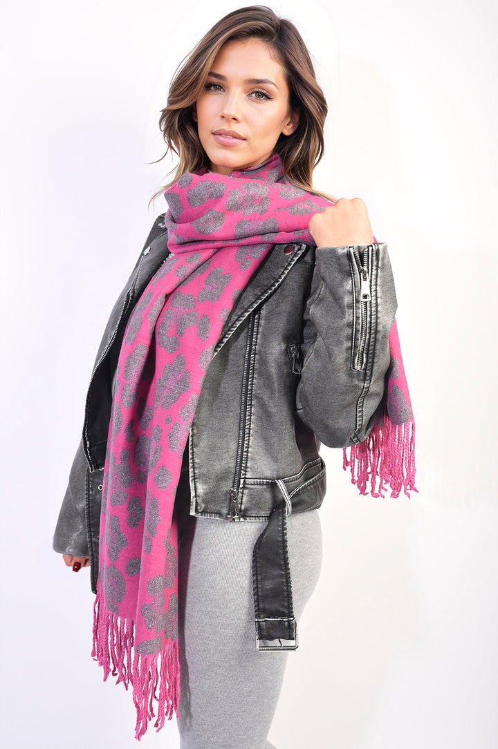 Woman wearing an Animal Print Scarf with Tassel, highlighting its bold design and tassel accents, perfect for adding flair to any outfit.