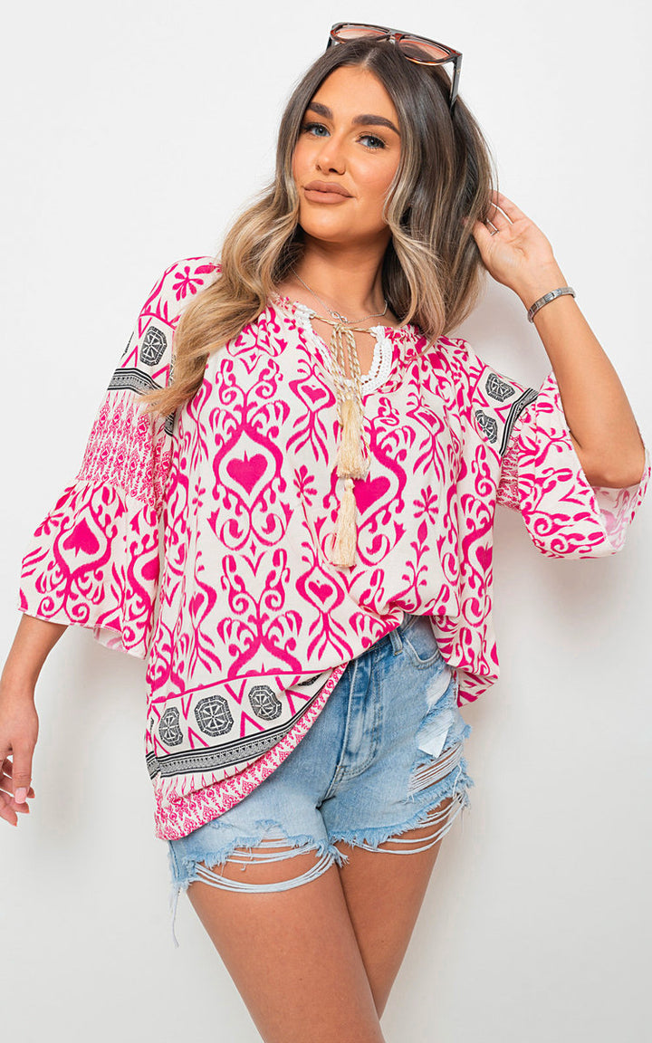 Boho Printed Tassel Tie Neck Long Sleeve Loose Tops modeled by a woman, showcasing its tassel detail and casual fit. Ideal for stylish, bohemian-inspired outfits.