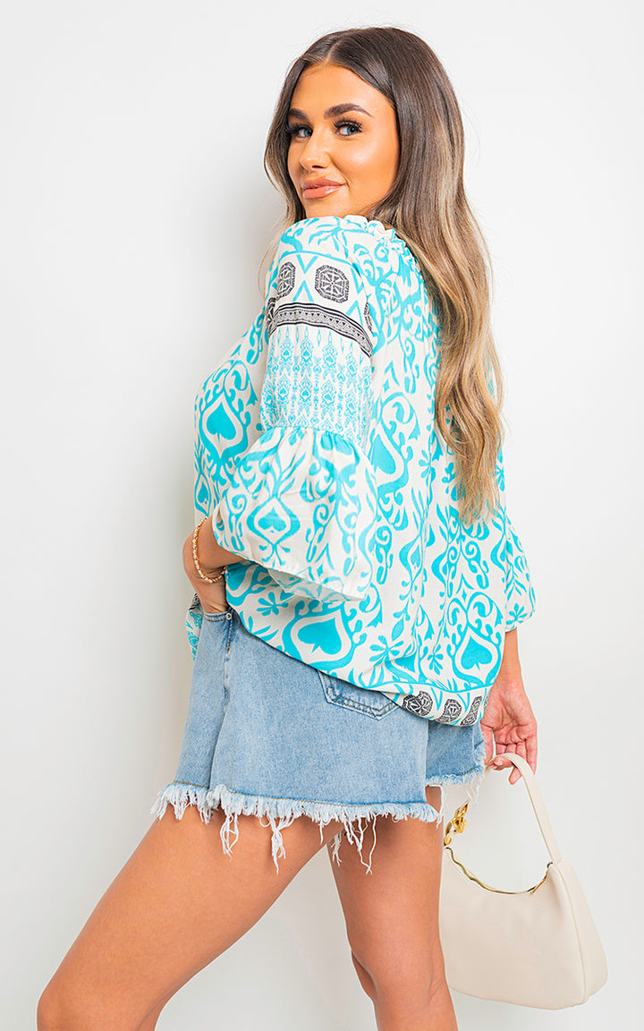 Boho Printed Tassel Tie Neck Long Sleeve Loose Tops worn with a short jean skirt, highlighting the top's intricate boho-inspired print and tassel details.