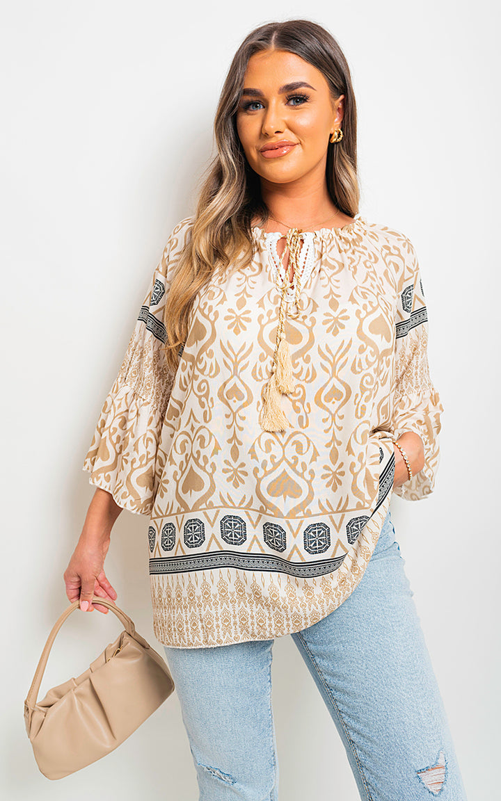 Woman models Boho Printed Tassel Tie Neck Long Sleeve Loose Tops, showcasing its bohemian design with tassel detail, ideal for stylish casual wear.