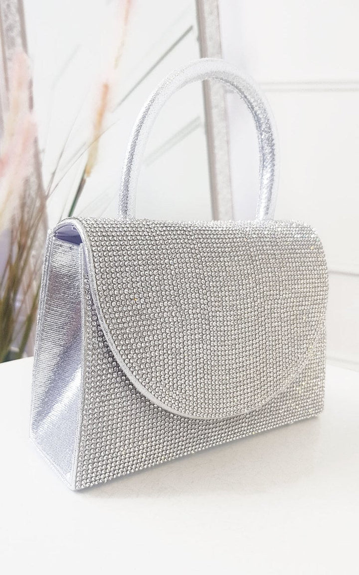 Diamante Embellished Handbag with rhinestones, featuring a detachable silver shoulder strap and metallic shine, ideal for pairing with a printed maxi dress.