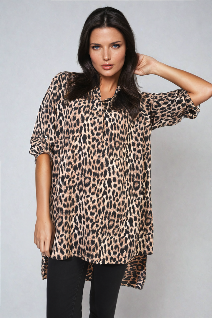 Woman modeling Oversized Leopard Print Button Down Batwing Sleeve Top, showcasing its relaxed fit and trendy batwing sleeves, ideal for casual or stylish outings.