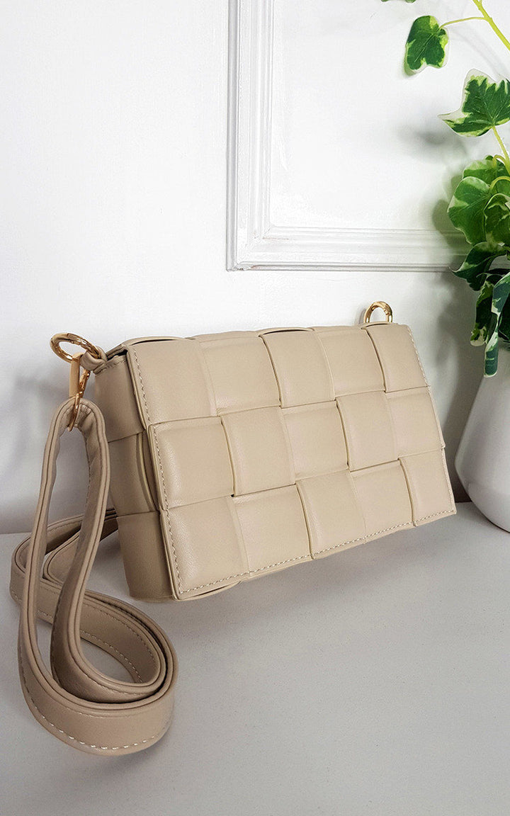 Padded Shoulder Bag with Chain Detail on a white surface, featuring a stylish design with a statement gold chain and adjustable strap for versatile carrying.