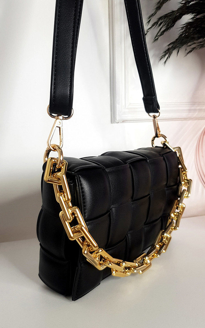 Padded Shoulder Bag with Chain Detail: Black faux leather handbag featuring a statement gold chain and adjustable strap, perfect for chic and stylish everyday or holiday use.