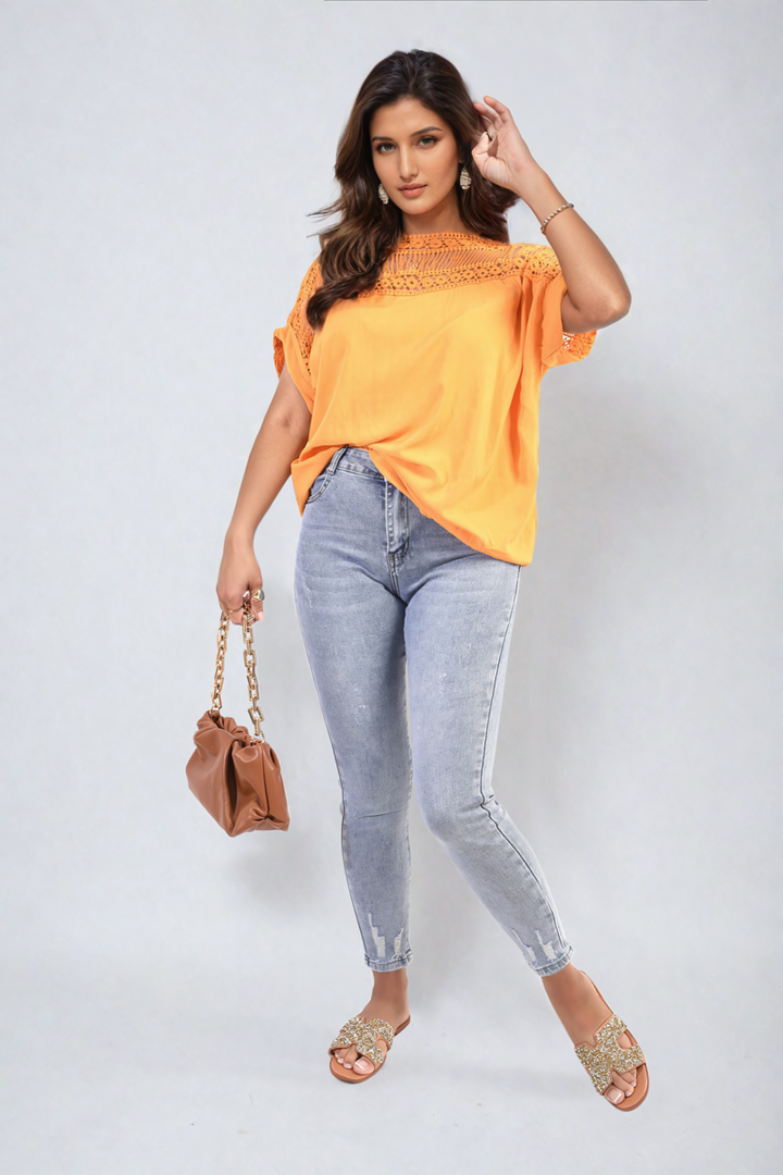 Woman wearing Sevyn Distressed High Waisted Jeans with a casual yellow shirt, showcasing the trendy distressed style and flattering high-waisted fit.