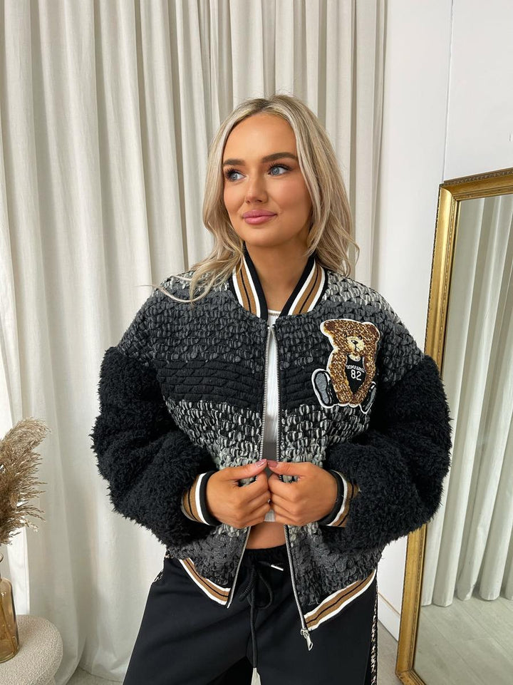 Woman wearing the Sylvia Teddy Textured Bomber Jacket, showcasing its plush texture and classic bomber style, perfect for casual hangouts or chilly adventures.