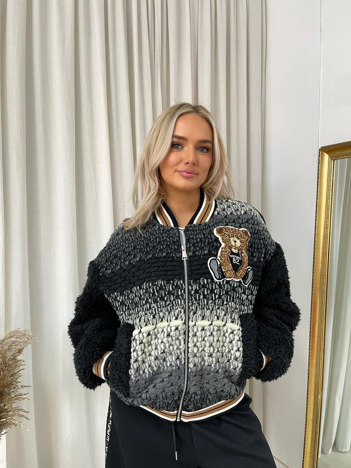 Woman wearing the Sylvia Teddy Textured Bomber Jacket, showcasing its plush texture and classic bomber style, ideal for casual and chic outfits.