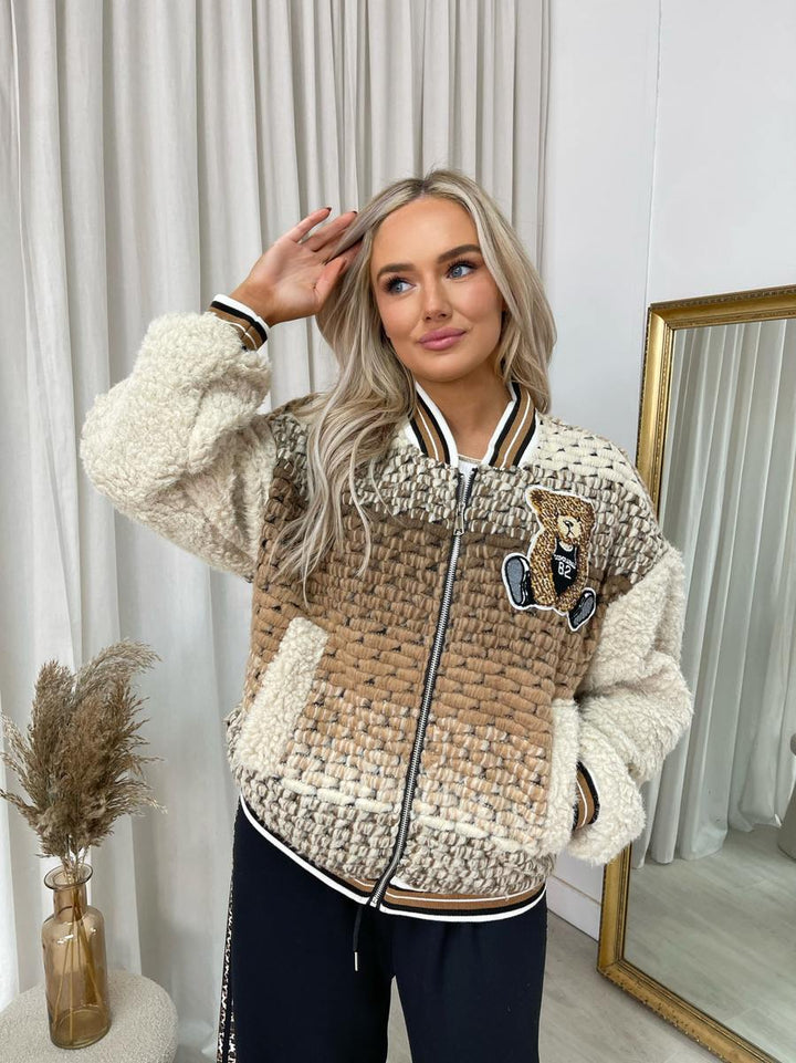 Sylvia Teddy Textured Bomber Jacket, featuring a plush teddy texture and classic bomber style, worn by a woman indoors. Perfect for casual, cozy outings.