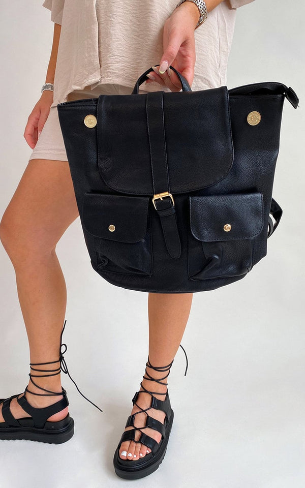 Woman holding the Tabitha Faux Leather Shoulder Bag from iKrush, showcasing its sleek design and ample size, perfect for organizing essentials stylishly.