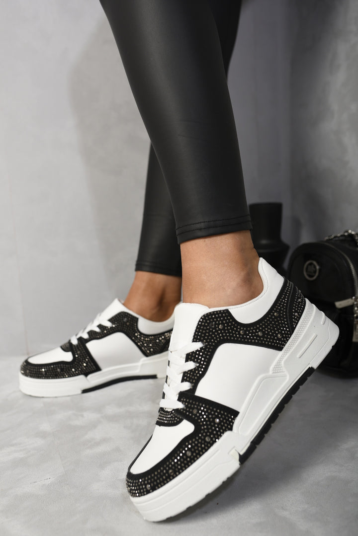 Sparkly Crystal Embellished Trainers showcasing dazzling crystals, worn with black leggings and white sneakers, perfect for adding glam and comfort to any outfit.