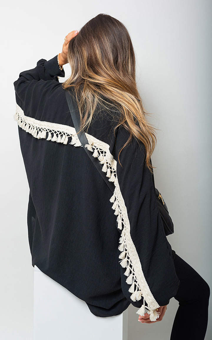 Vanessa Oversized Long Sleeve Tassel Trim Top featuring an oversized fit and tassel details, perfect for a boho-chic look.