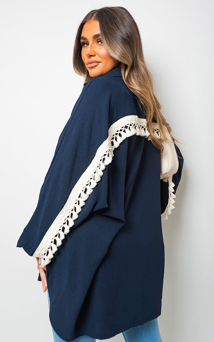 Vanessa Oversized Long Sleeve Tassel Trim Top, showcasing boho-inspired, oversized fit with tassel details for stylish casualwear. Perfect for holiday and everyday essentials.