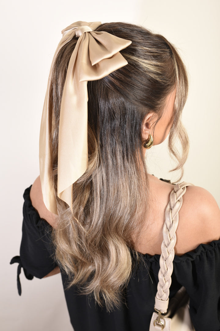 Elegant Big Bow Hair Clips adorn a woman's hairstyle, highlighting the accessory's sophisticated design suitable for enhancing everyday or special occasion looks.