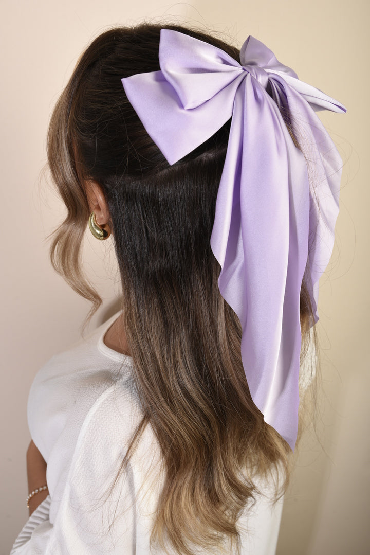 Elegant Big Bow Hair Clip in a woman's hair, showcasing its chic design and sophistication, perfect for enhancing holiday and everyday styles.