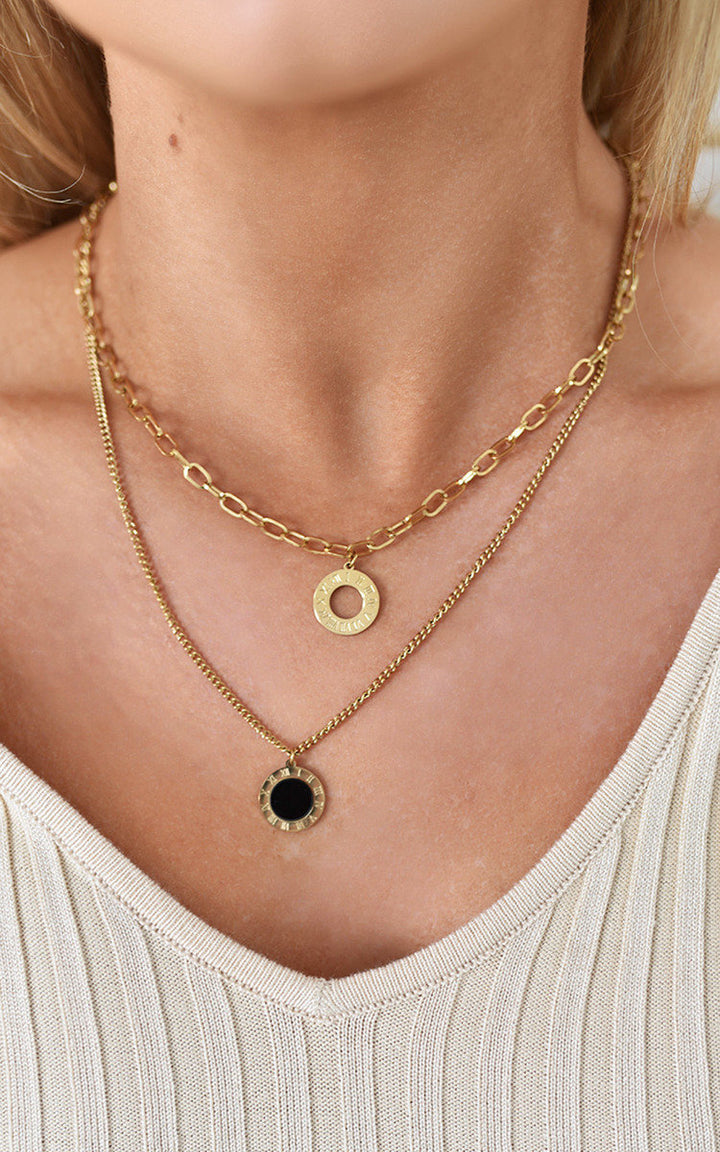 Woman wearing the Wren Two Layer Necklace, featuring a stylish design with two delicate chain layers, perfect for adding elegance to any outfit.