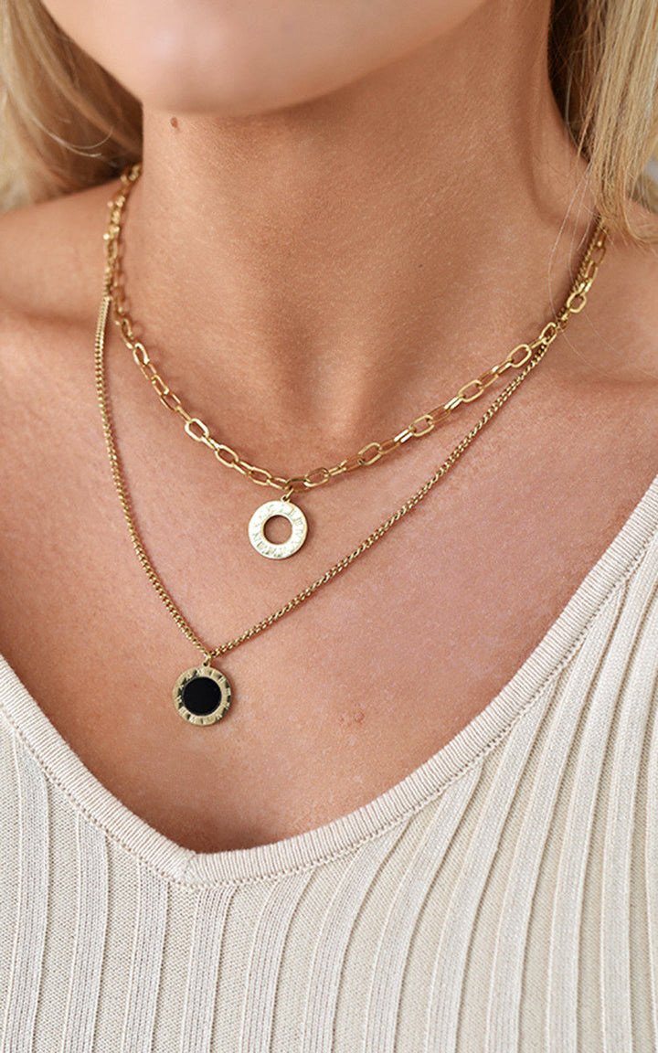 Woman wearing a Wren Two Layer Necklace, showcasing its elegant two-chain design, perfect for adding sophistication to any outfit.