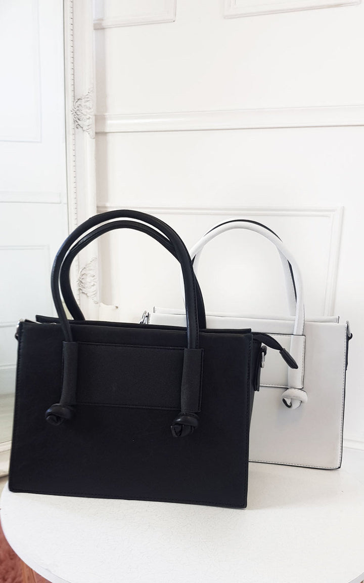 Faux Leather Handbag with black and white design, featuring a zip fastening, detachable shoulder strap, and silver hardware for a chic everyday look.