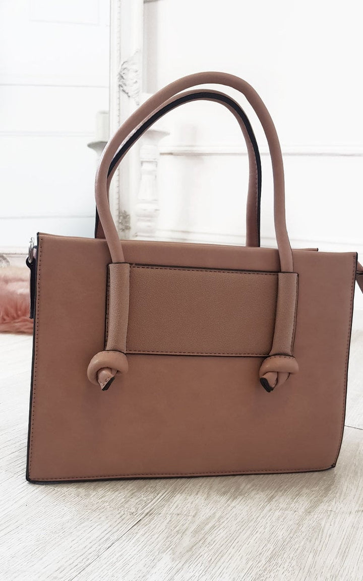 Faux Leather Handbag on wooden floor, featuring a zip fastening, silver hardware, inner compartments, handheld, and detachable shoulder strap, ideal for casual outings.