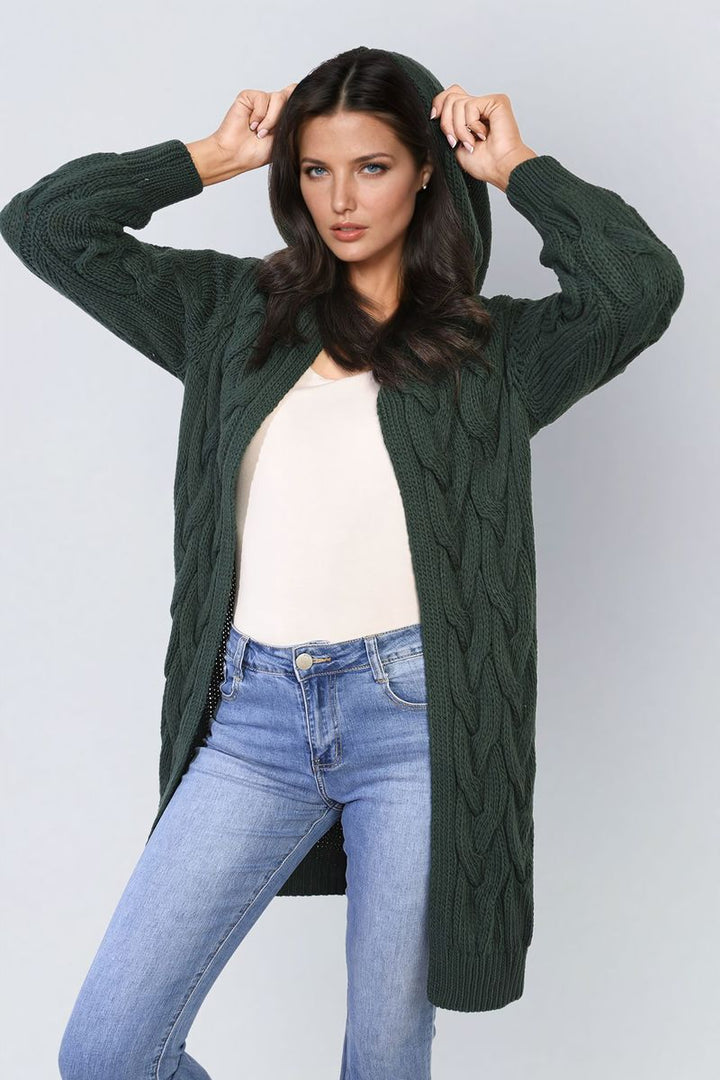 Woman wearing the Chunky Cable Knitted Oversized Longline Hooded Cardigan with blue jeans, showcasing its cozy, layered style perfect for holidays and everyday wear.