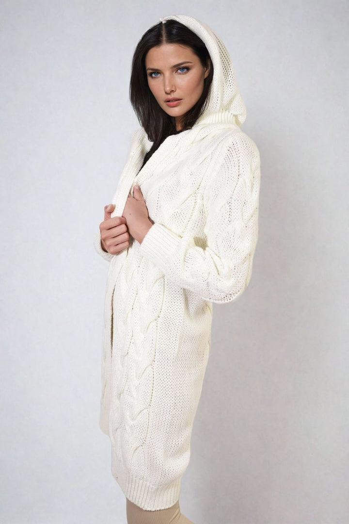 Woman wearing the Chunky Cable Knitted Oversized Longline Hooded Cardigan, showcasing its cozy and stylish design, perfect for layering on colder days.