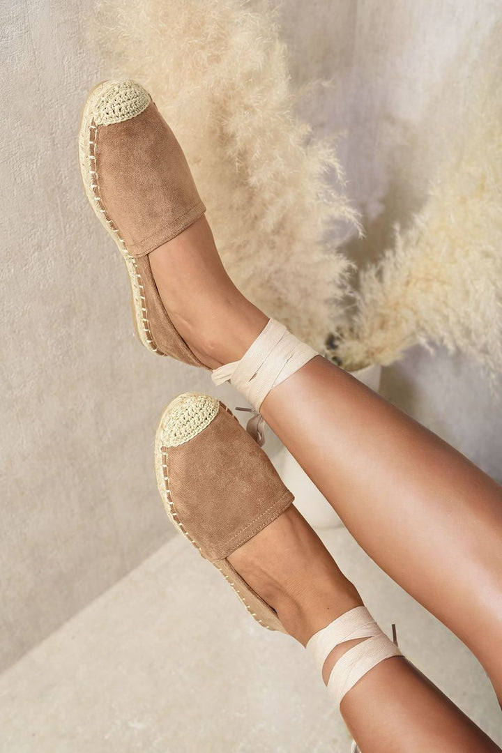 Zoey Tie Leg Espadrille Sandals on a person's feet, featuring a chic tie-leg design and classic espadrille sole, perfect for stylish summer outings.