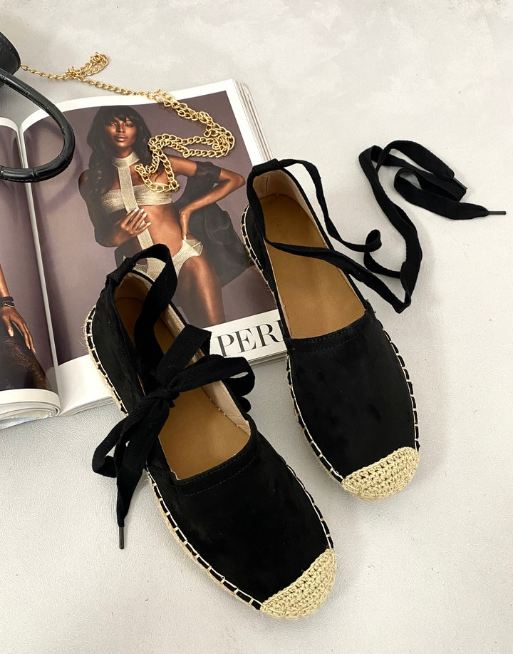 Tie Leg Espadrille Sandals with laces on a magazine, showcasing their tie-leg design and espadrille sole, perfect for stylish summer wear.